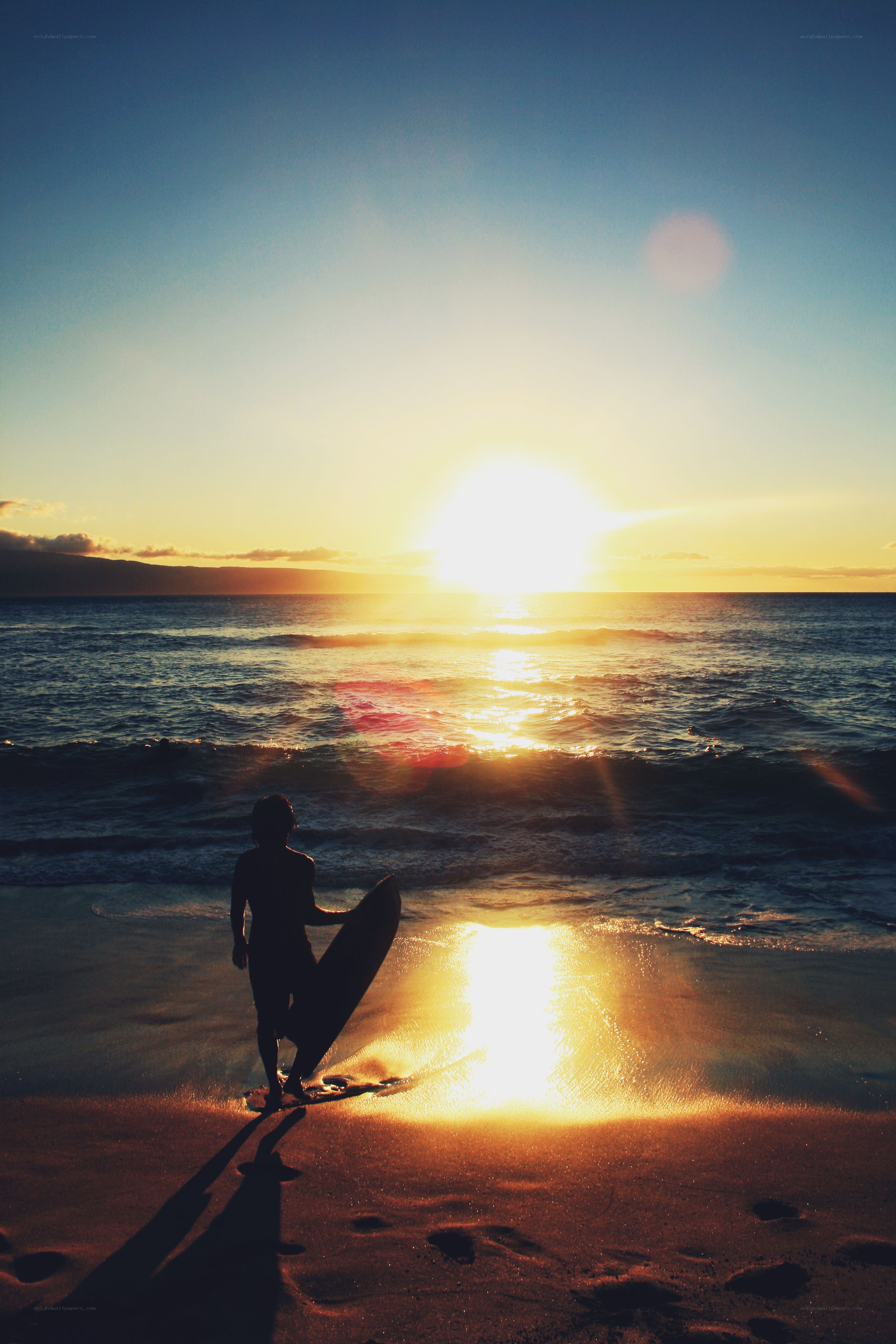 Surfer at sunset on the beach