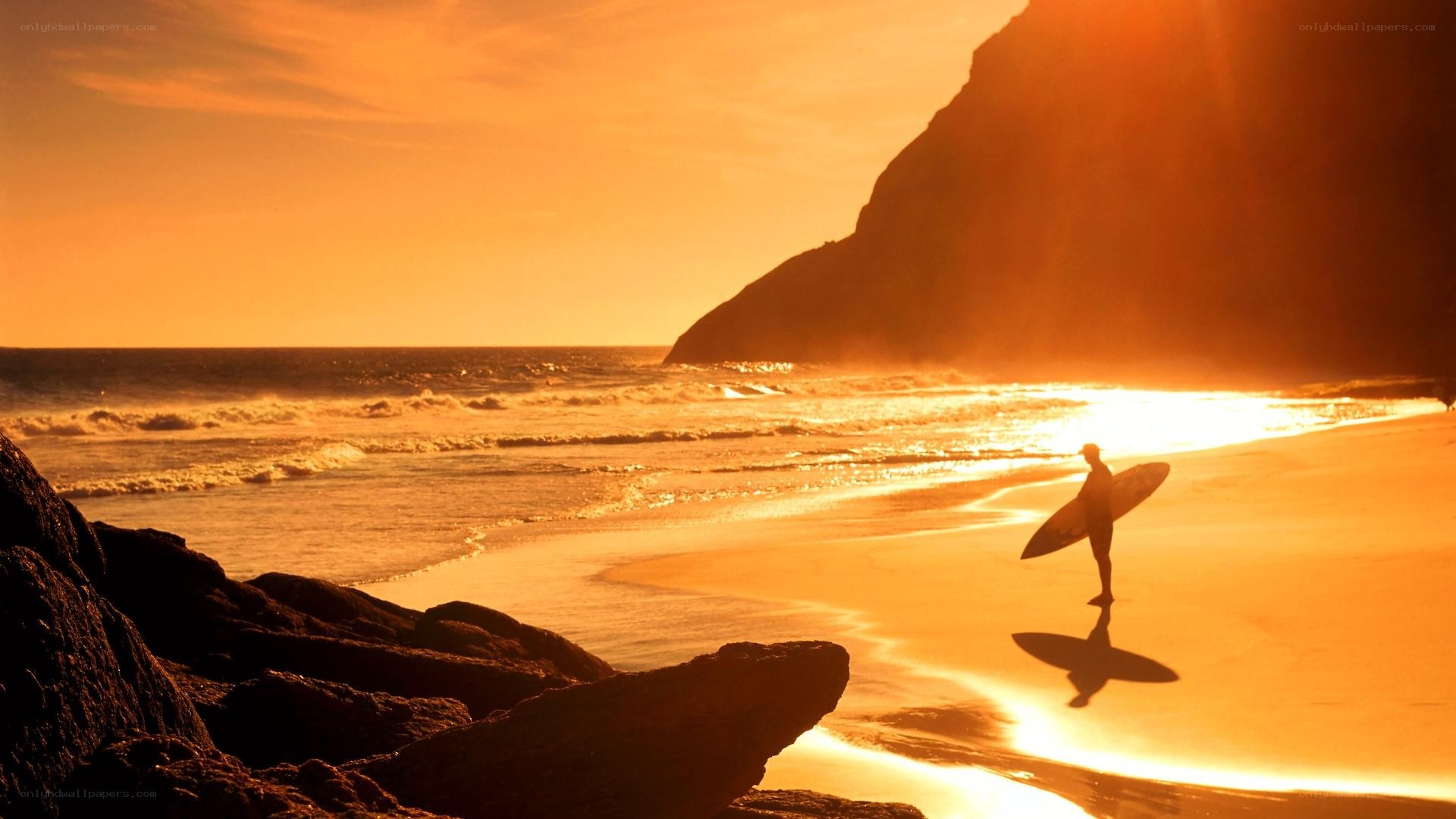 Surfer at sunset on the beach
