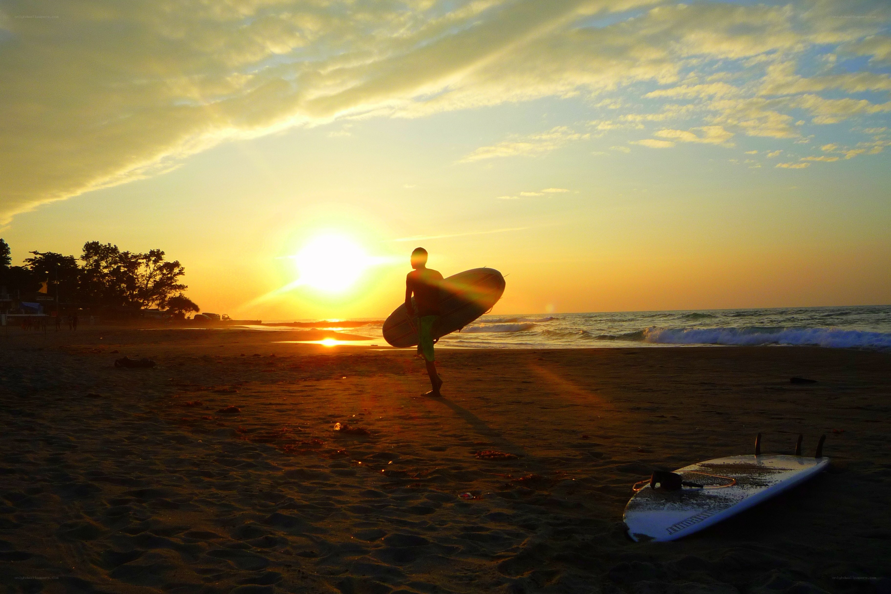 Surfer at sunset on the beach