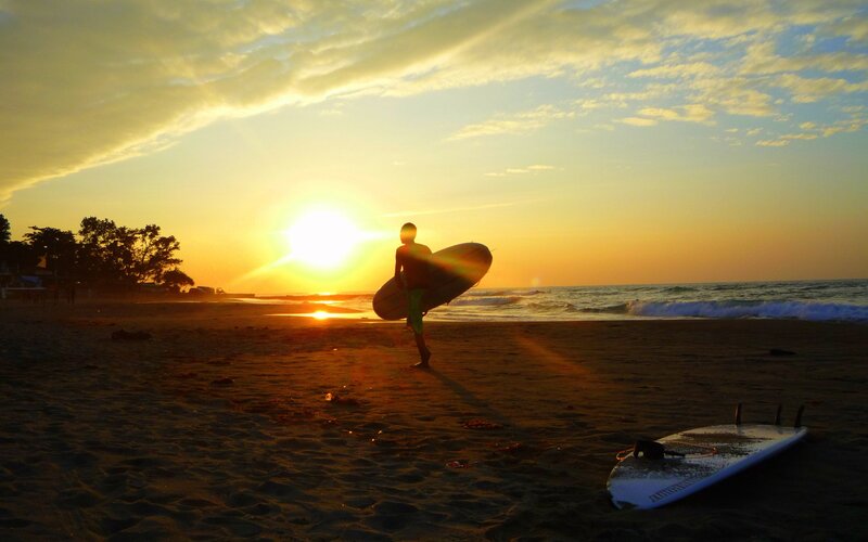 Surfer at sunset on the beach