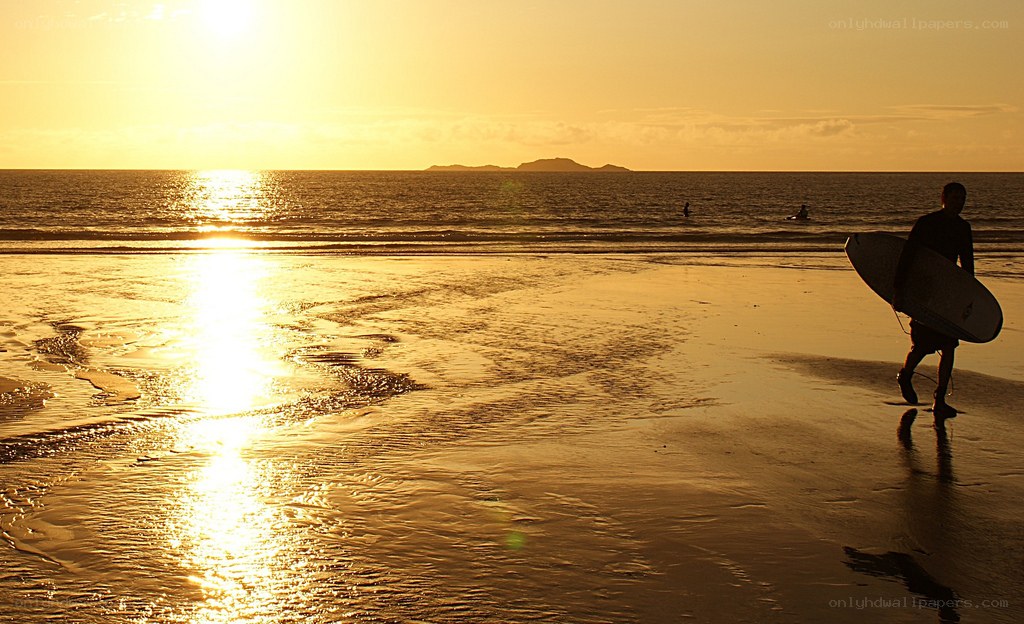 Surfer at sunset on the beach