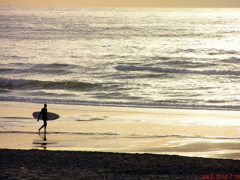 Surfer at sunset on the beach