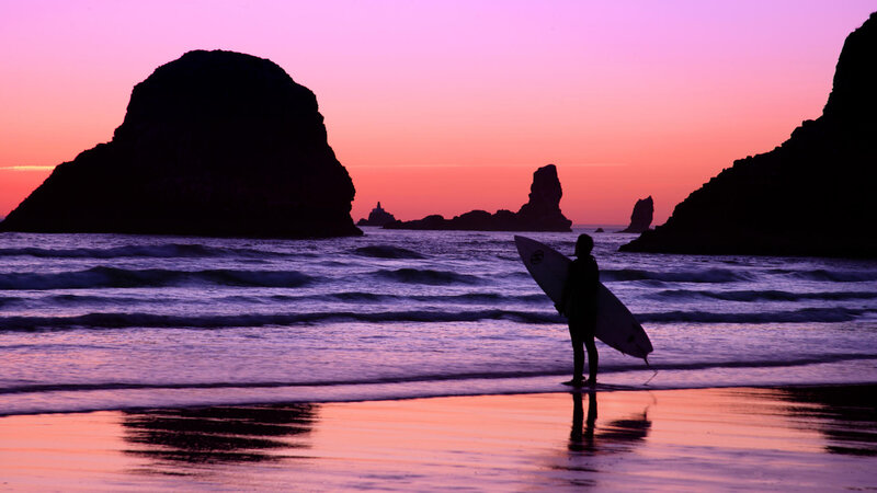 Surfer at sunset on the beach