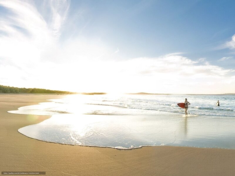 Surfer at sunset on the beach
