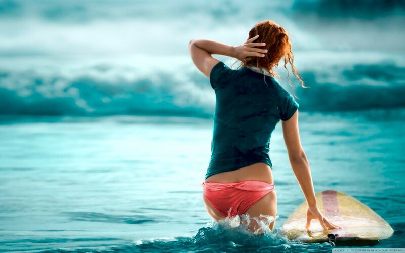 Surfer girl in ocean