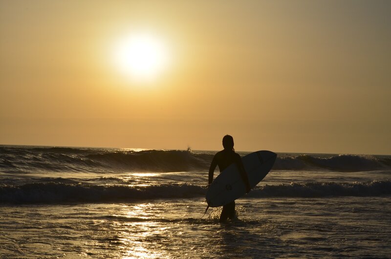 Surfer Holding Surfboard — Yellow, Serene
