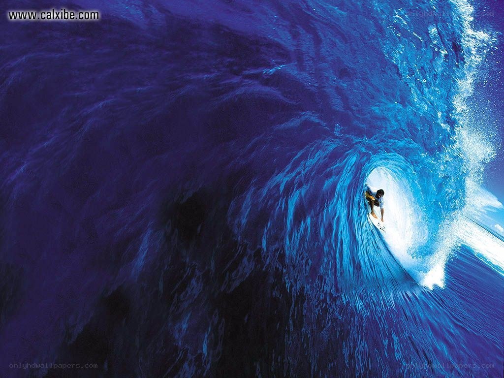 Surfer in a blue wave tunnel