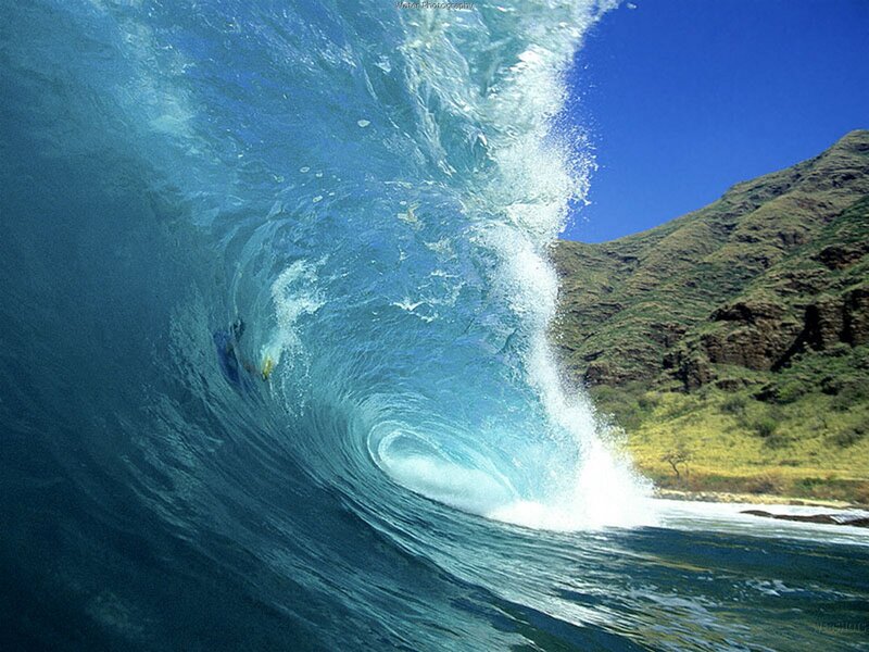 Surfer in a large ocean wave