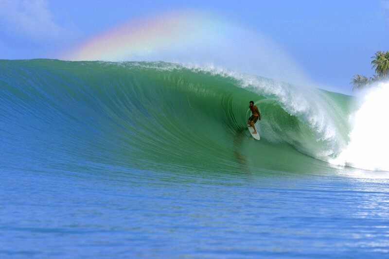 Surfer in a rainbow wave