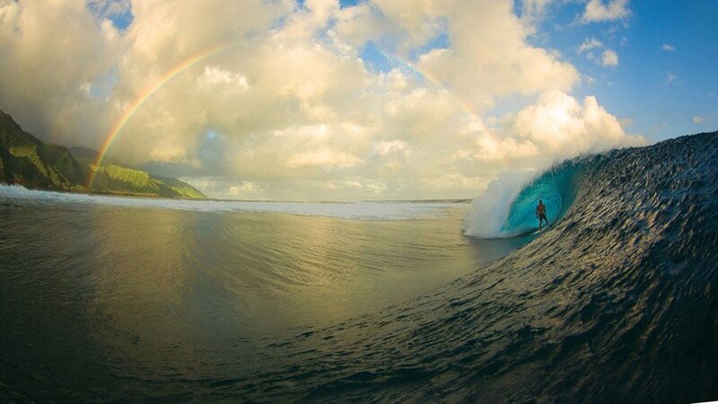 surfer in a rainbow wave
