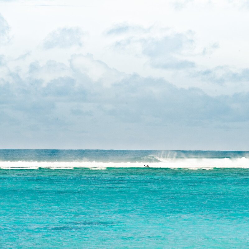 Surfer on a turquoise wave