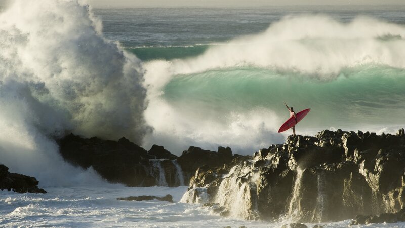 Surfer on Rocky Cliff — Green, Dramatic, Afternoon