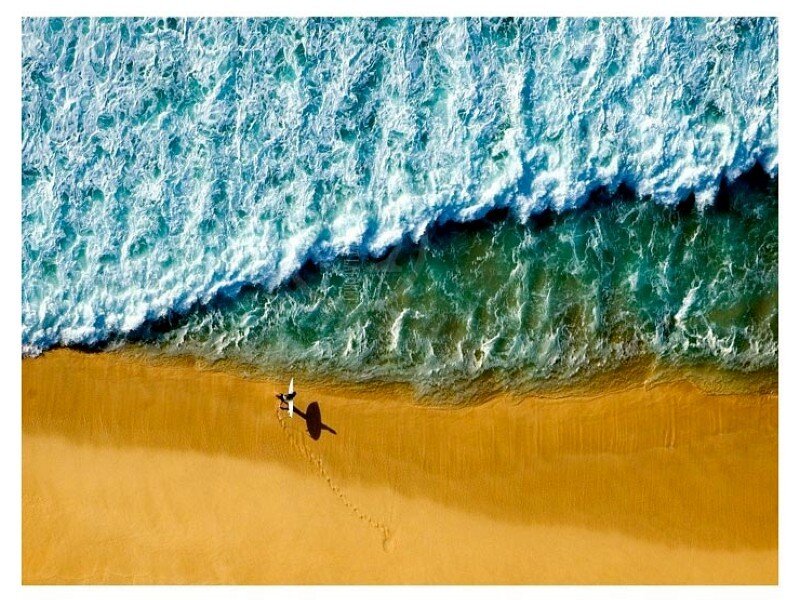 Surfer on sandy beach