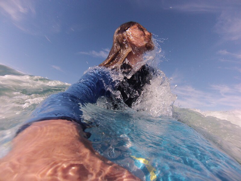 surfer paddling in ocean