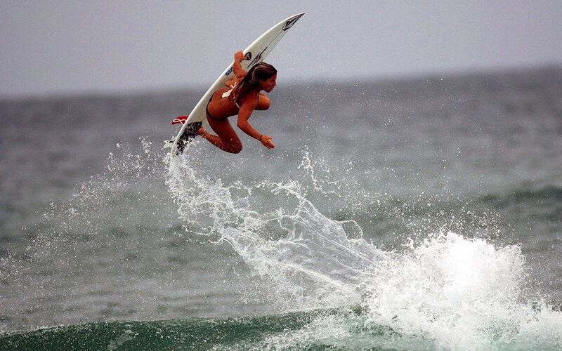 Surfer performing aerial maneuver