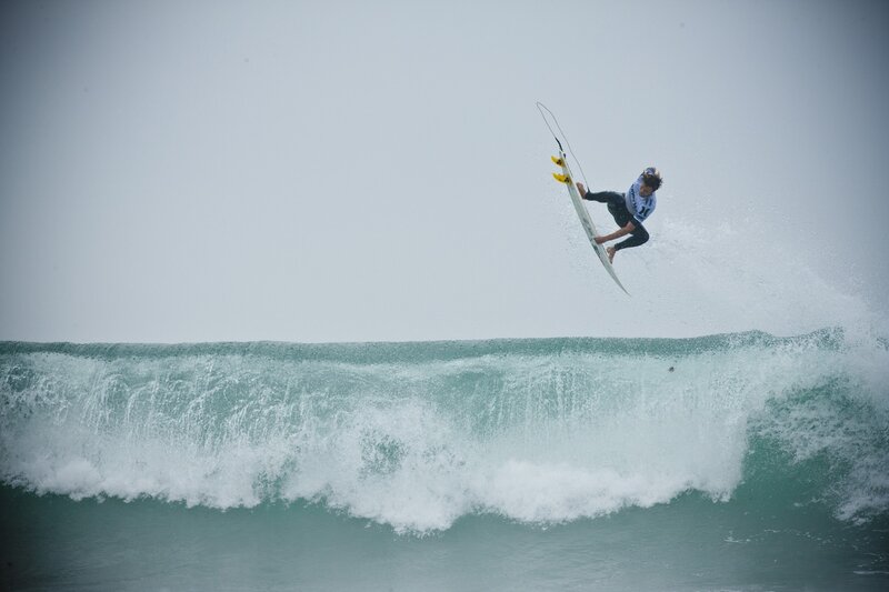 Surfer Performing Aerial Maneuver — Blue
