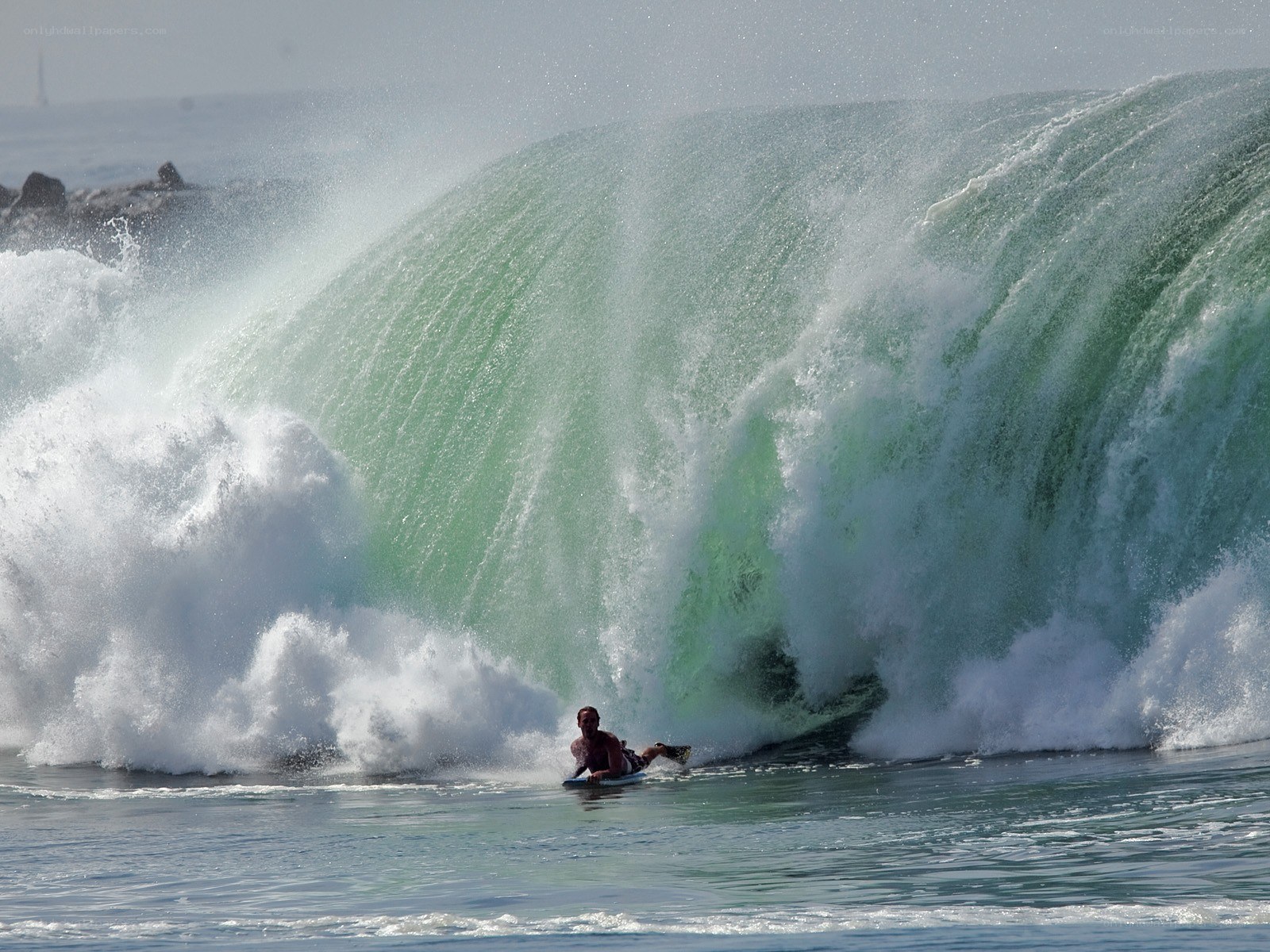 Surfer rides large wave