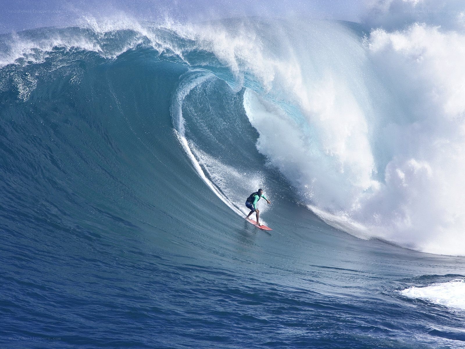 Surfer riding large ocean wave