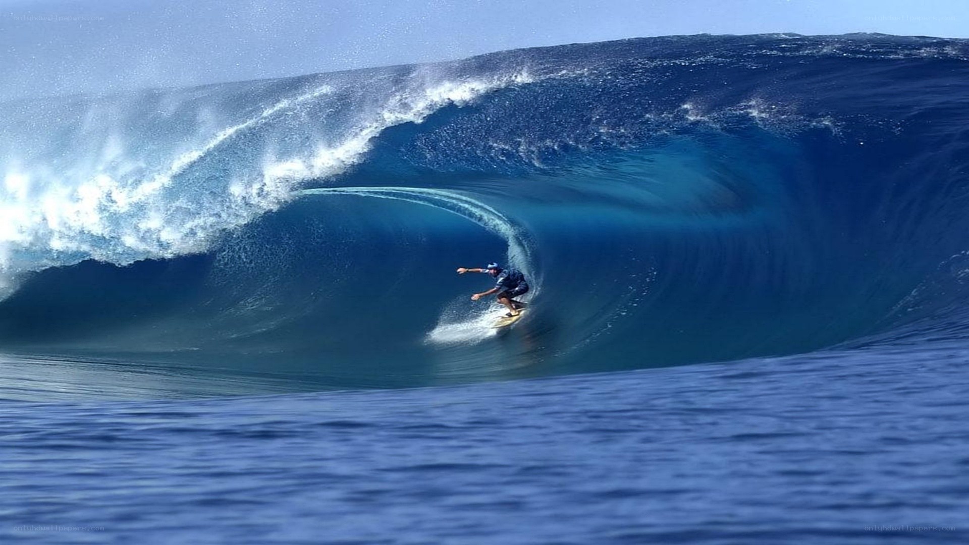 Surfer riding large ocean wave