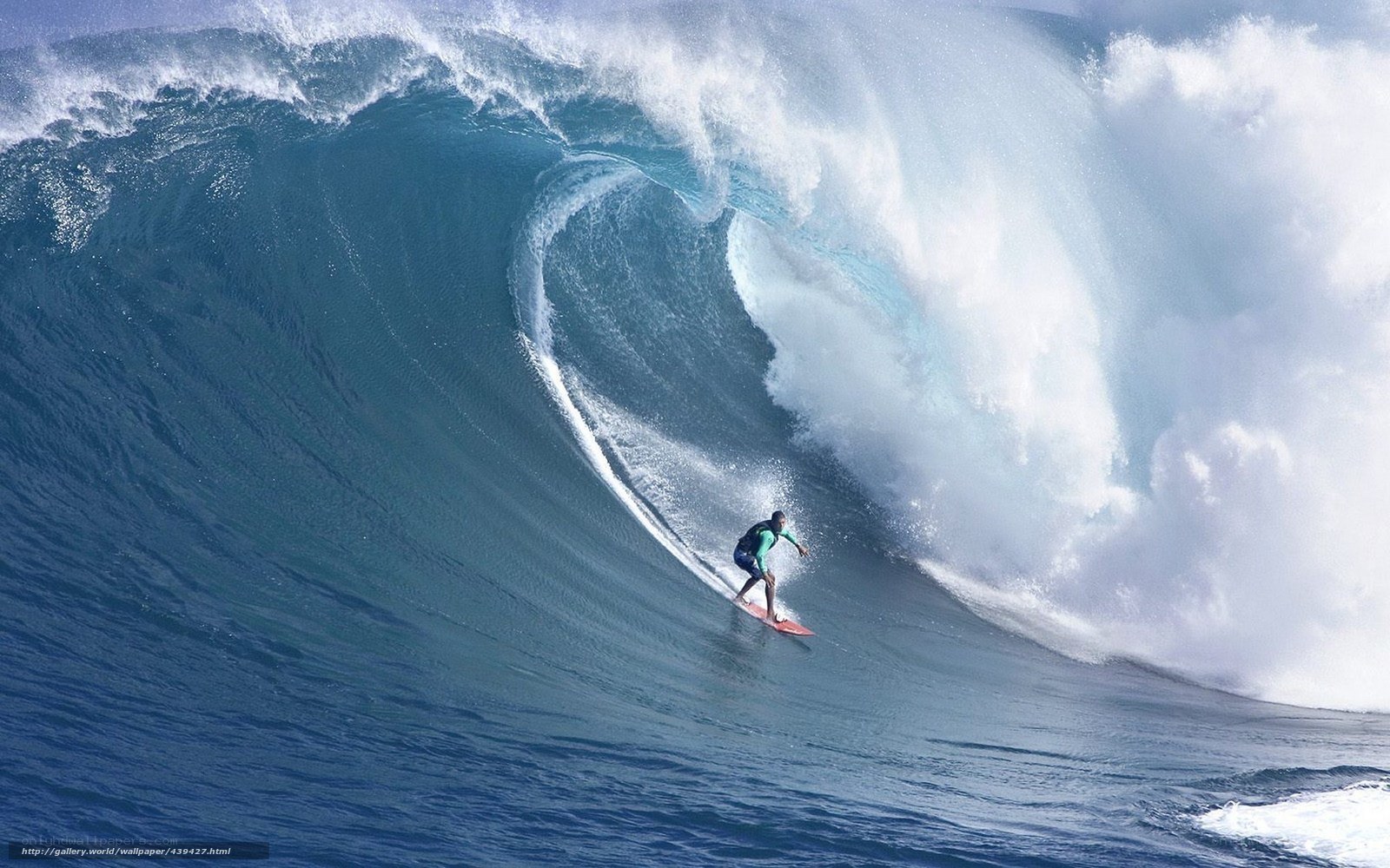 Surfer riding large ocean wave
