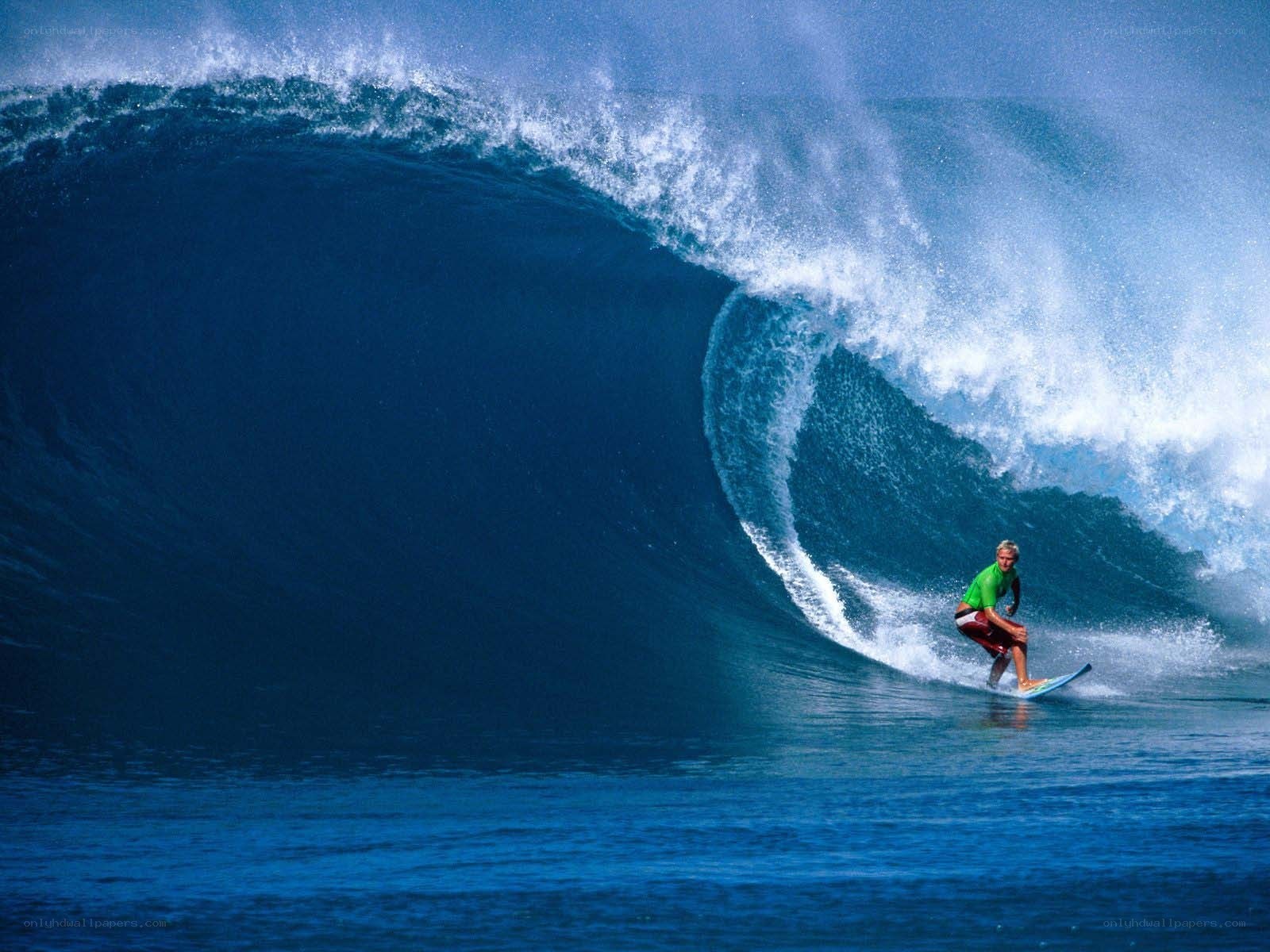 Surfer riding large ocean wave