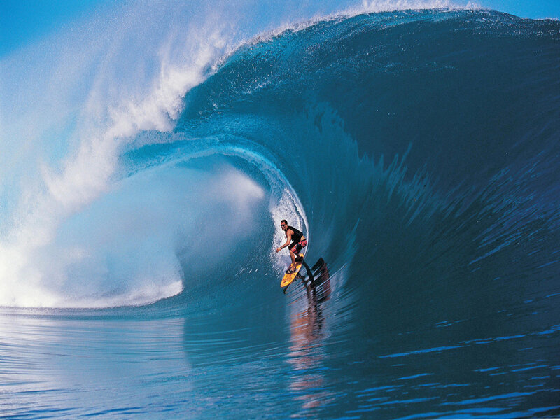 Surfer riding large wave