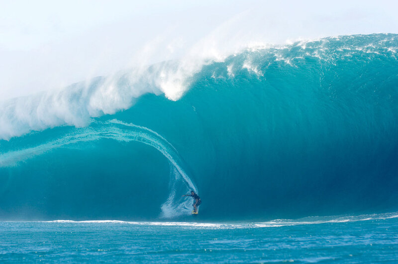 Surfer riding large wave