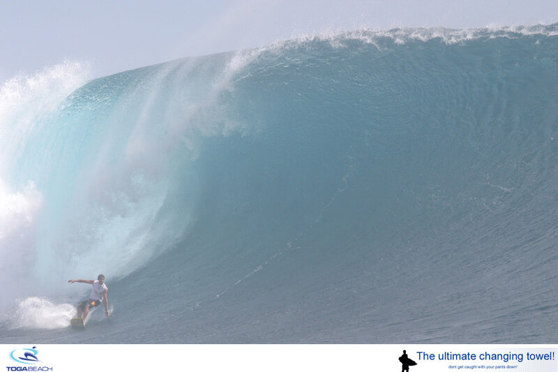 Surfer riding large wave