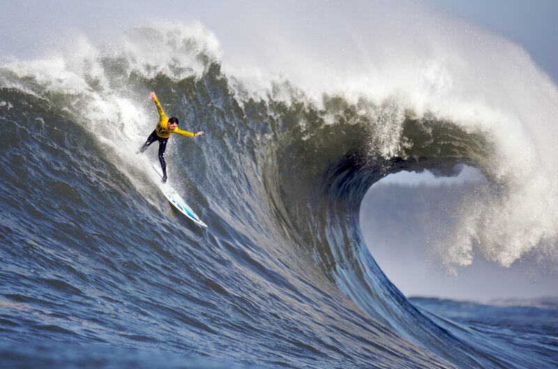 Surfer riding large wave