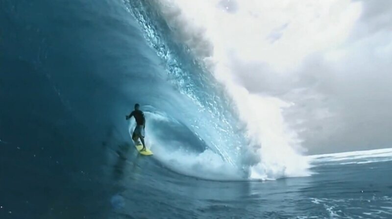 Surfer riding large wave