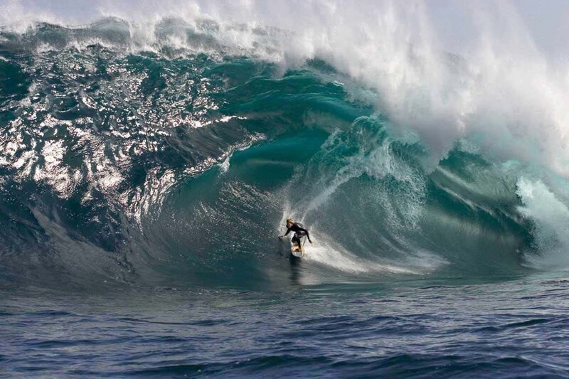 Surfer riding large wave