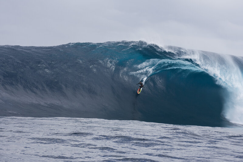 Surfer riding large wave