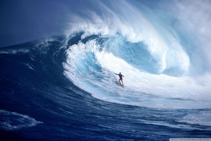 Surfer riding large wave