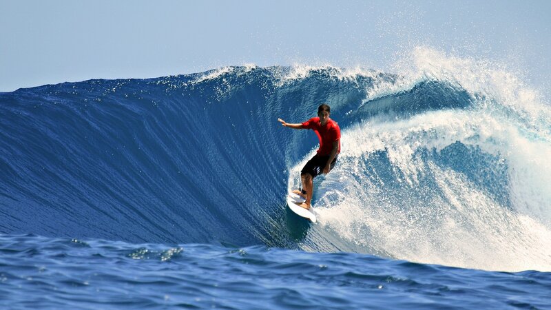 Surfer riding large wave