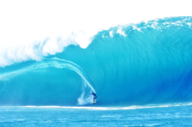 Surfer riding large wave