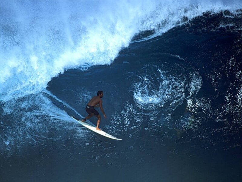 Surfer riding large wave