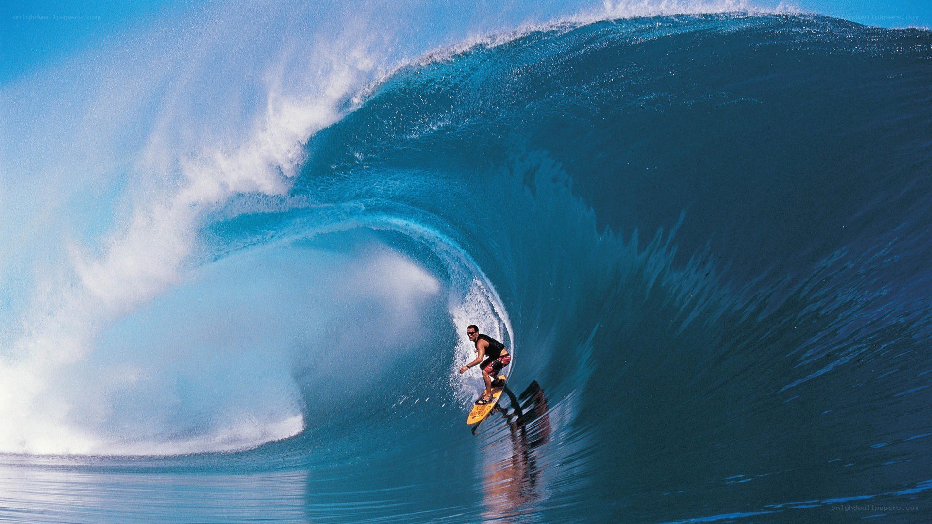 Surfer riding large wave
