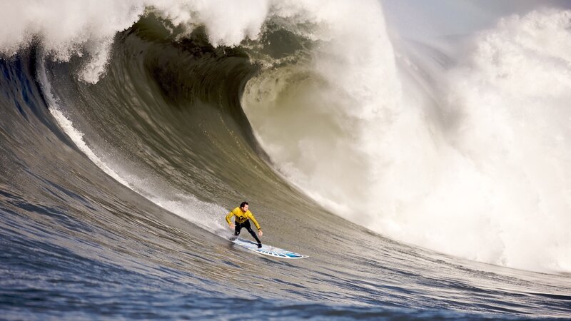 Surfer riding large wave