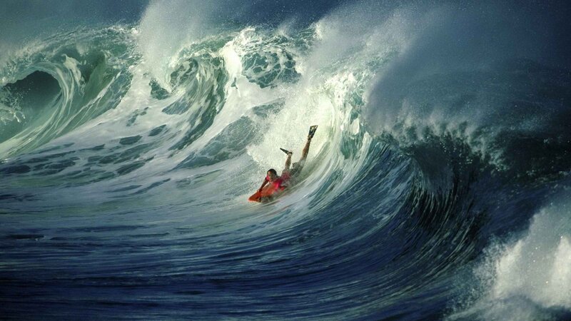 Surfer riding large wave