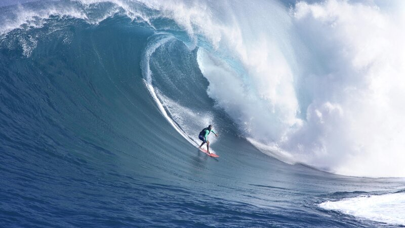 Surfer riding large wave