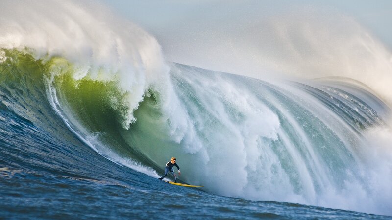 Surfer riding large wave