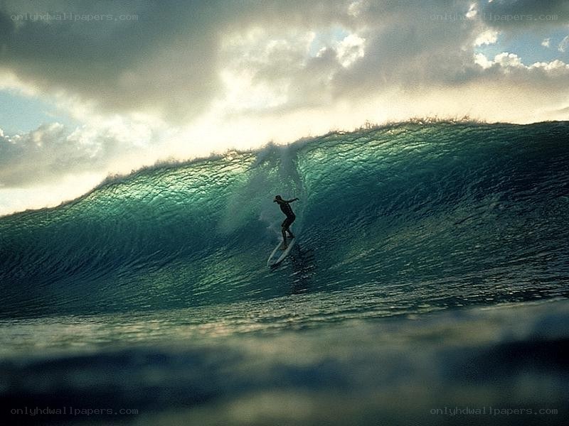 Surfer riding large wave