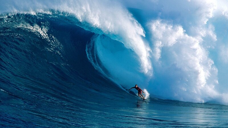 Surfer riding large wave