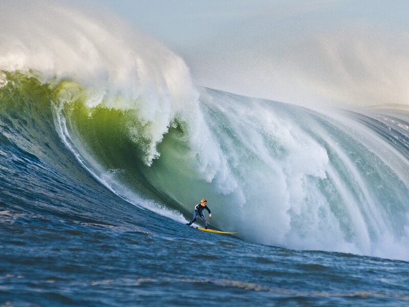Surfer riding large wave