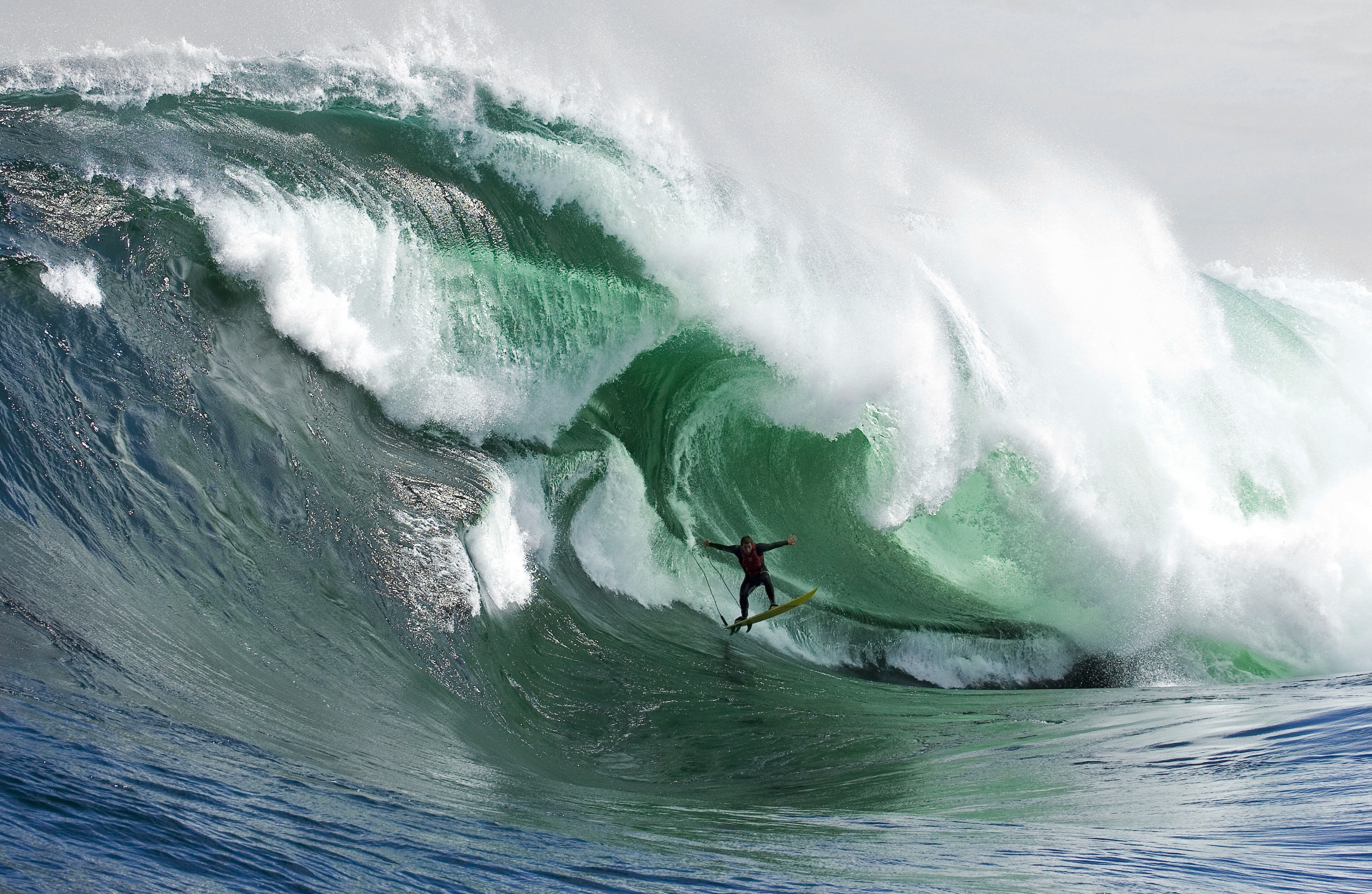 Surfer riding large wave