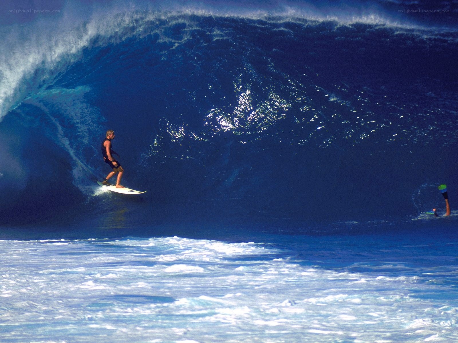 Surfer riding large wave