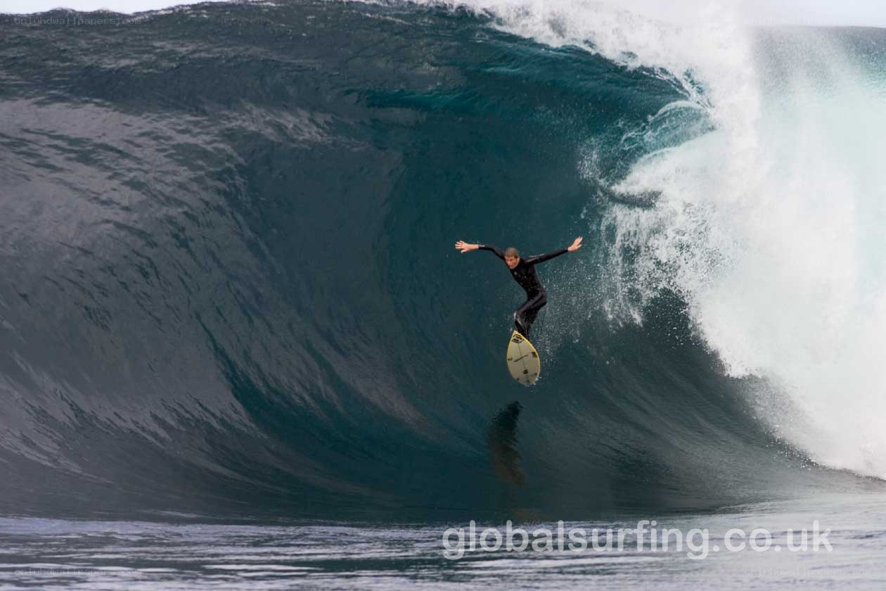 Surfer riding large wave