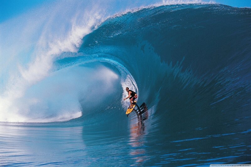 Surfer riding large wave