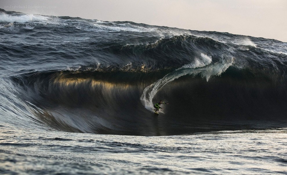 Surfer riding large wave tunnel