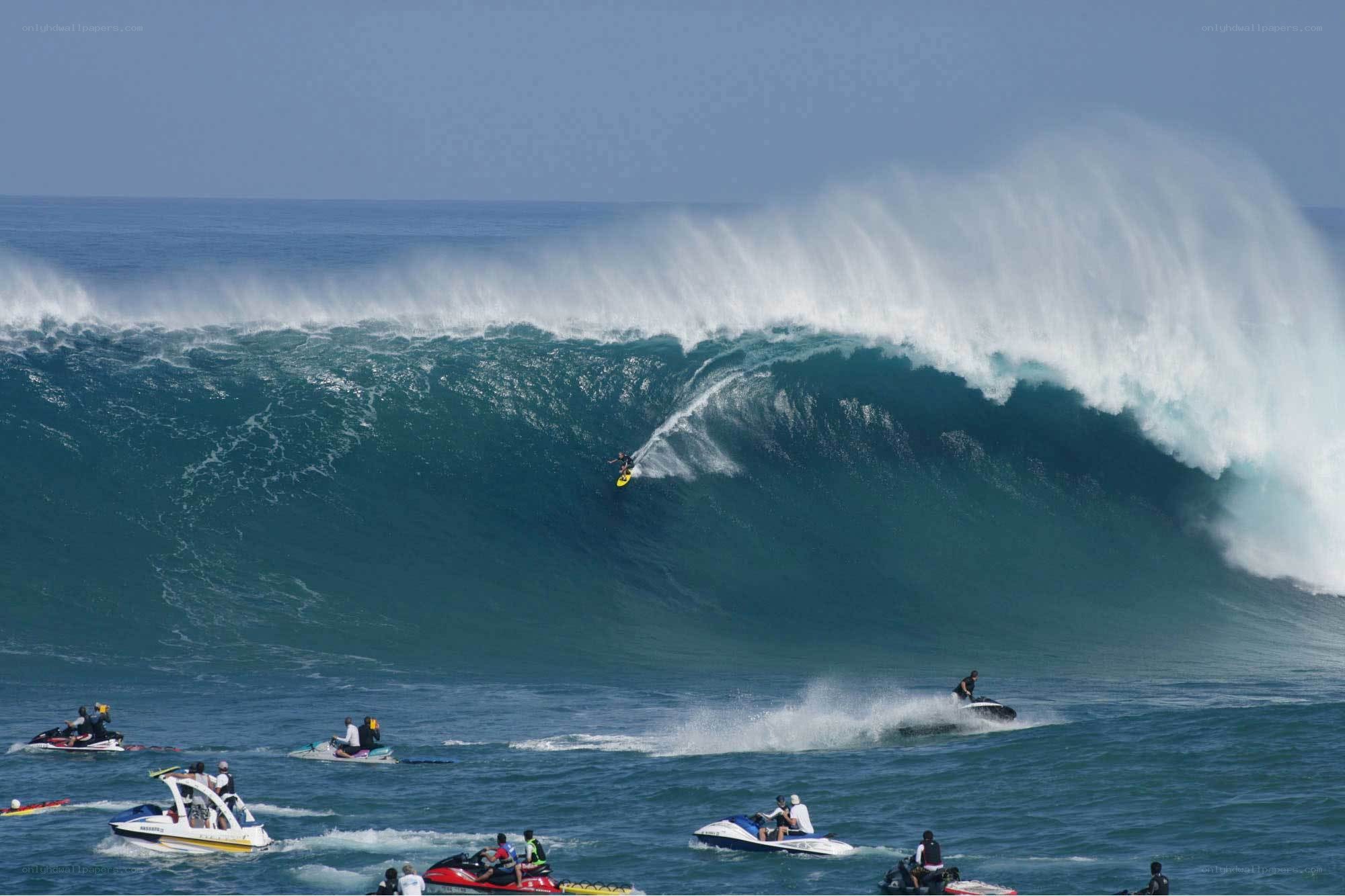 Surfer riding massive wave
